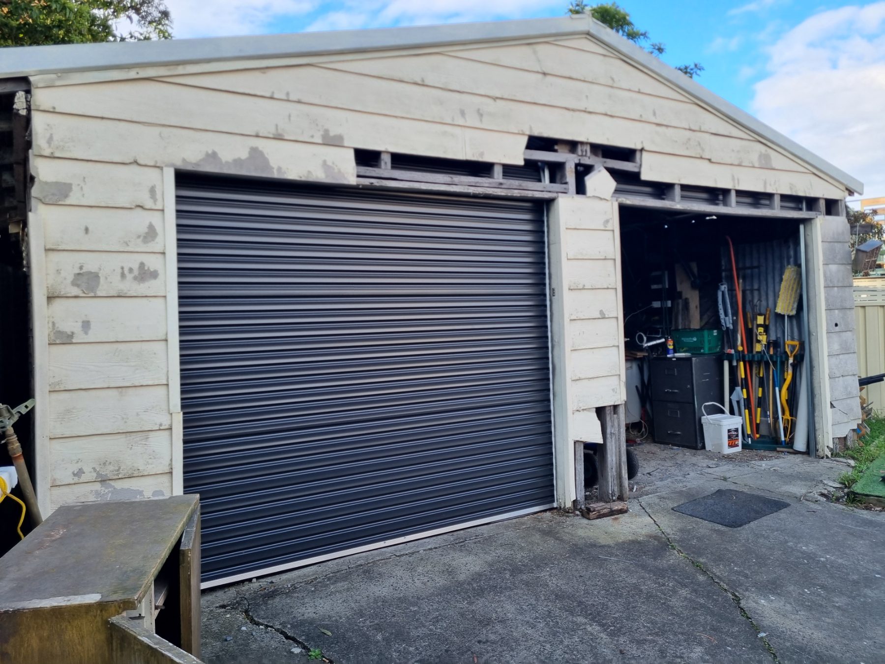 Before: Garage re-clad in vinyl cladding with new roller door
